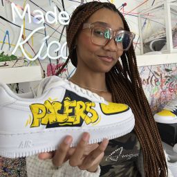 Crafty - Featured Image - Woman holding a sneaker crafted at Kicasso.