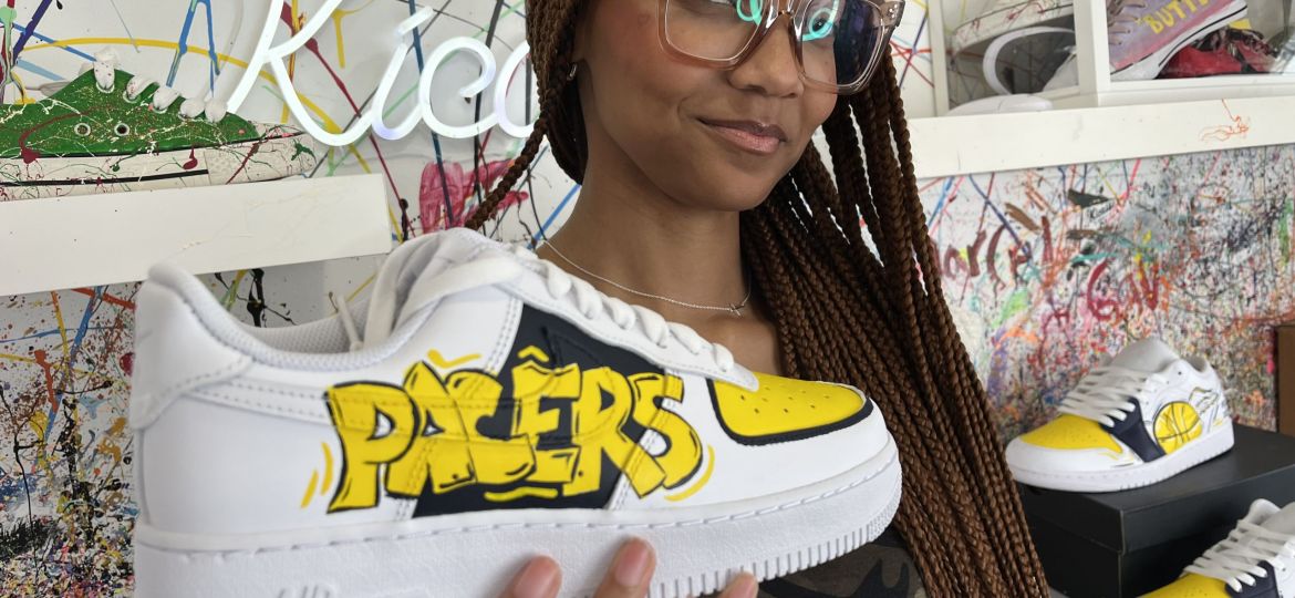 Crafty - Featured Image - Woman holding a sneaker crafted at Kicasso.