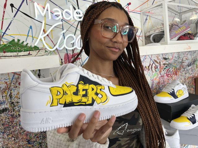 Crafty - Featured Image - Woman holding a sneaker crafted at Kicasso.