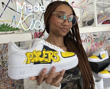 Crafty - Featured Image - Woman holding a sneaker crafted at Kicasso.