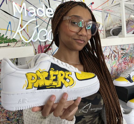 Crafty - Featured Image - Woman holding a sneaker crafted at Kicasso.