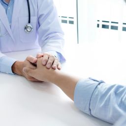 Doctor holding a patient's hand.