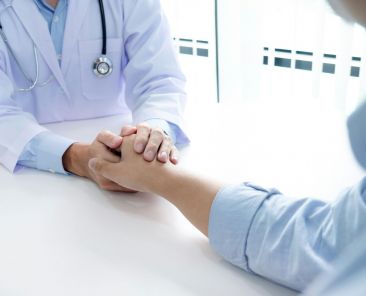 Doctor holding a patient's hand.