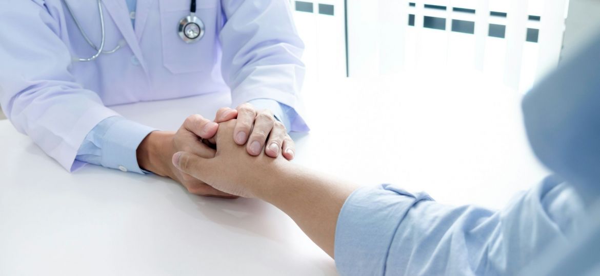 Doctor holding a patient's hand.