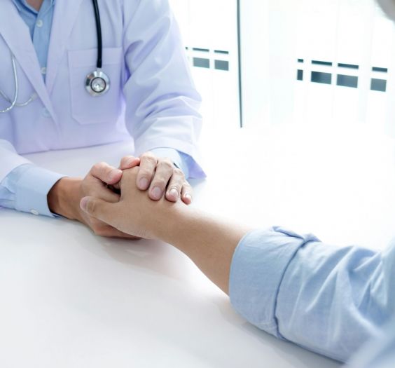 Doctor holding a patient's hand.