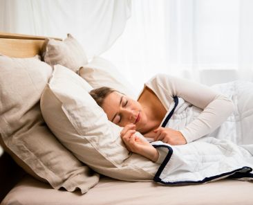 Person sleeping in bed.