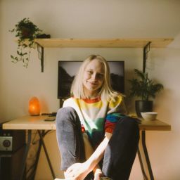 Woman sitting at her desk smiling to the camera