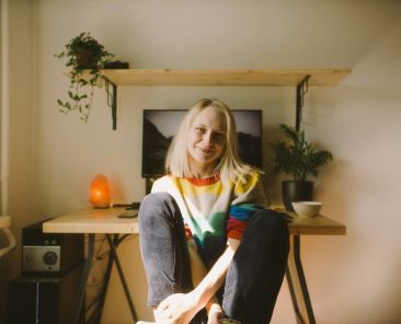 Woman sitting at her desk smiling to the camera