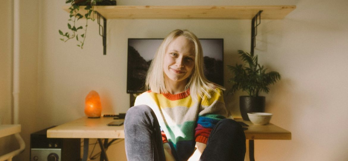 Woman sitting at her desk smiling to the camera