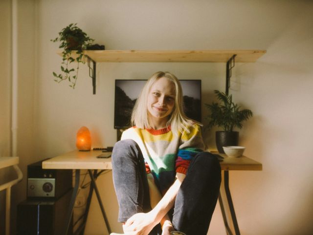 Woman sitting at her desk smiling to the camera