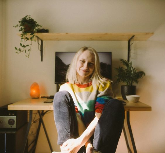 Woman sitting at her desk smiling to the camera