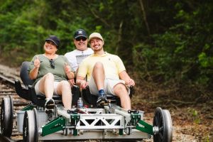 a trio enjoying riding on a rail bike