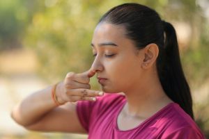 women practicing nostril breathing - pranayama
