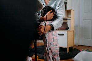 A child being hugged.