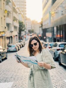 woman holding a map in the middle of a Lisbon street