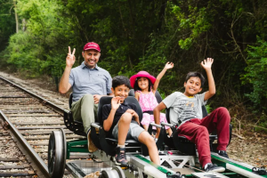 family riding in a rail car in Nickel Plate