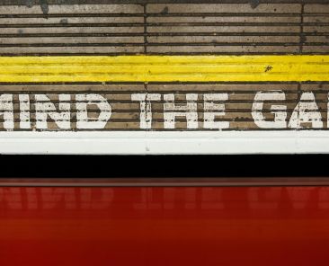 "Mind the Gap" painted on a wall at a train station