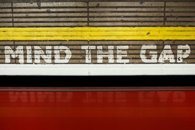 "Mind the Gap" painted on a wall at a train station