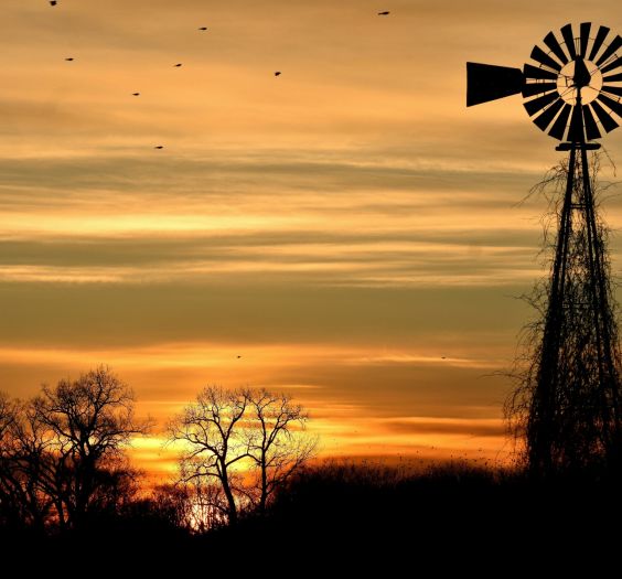 Windmill against a sunset sky