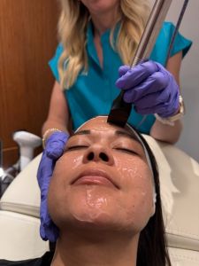 woman lying back and receiving a facial at Alternate View