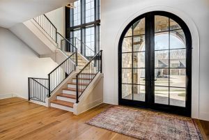 inside the entry way of a home with a long staircase to the left
