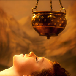 Shirodhara therapy - woman lying down as oil drips on her forehead