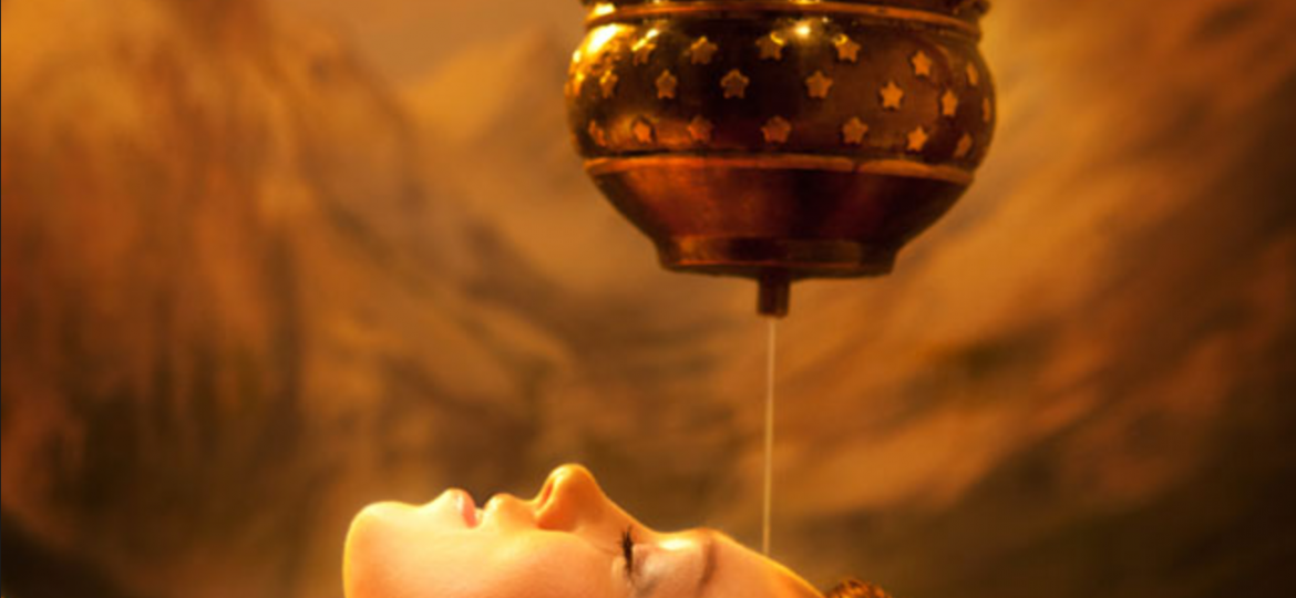 Shirodhara therapy - woman lying down as oil drips on her forehead