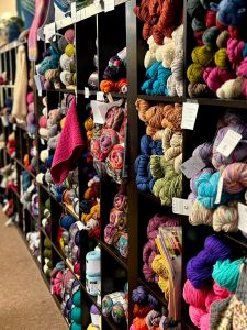 shelves are yarn skeins at Village Yarn Company
