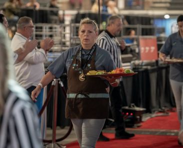 Cindy Hawkins carrying a tray of sweets at a competition