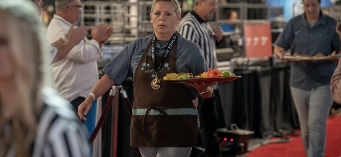 Cindy Hawkins carrying a tray of sweets at a competition
