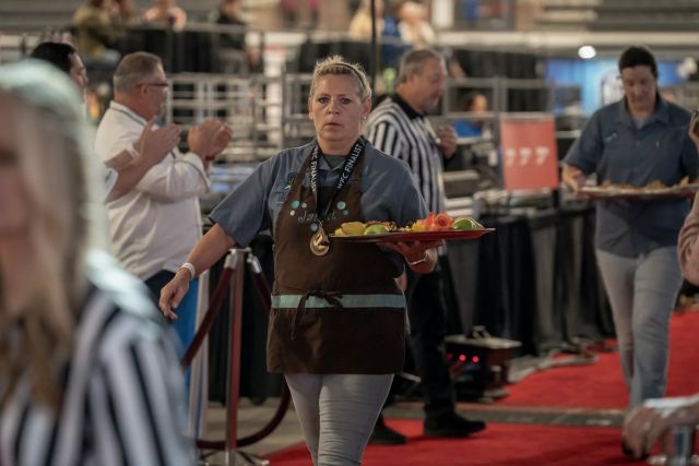 Cindy Hawkins carrying a tray of sweets at a competition