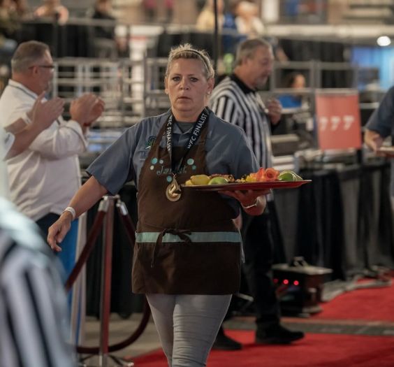 Cindy Hawkins carrying a tray of sweets at a competition
