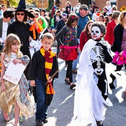 kids and parents dressed up at a Halloween festival
