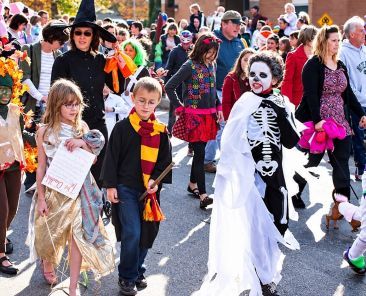 kids and parents dressed up at a Halloween festival