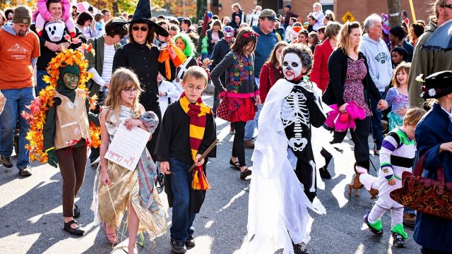kids and parents dressed up at a Halloween festival