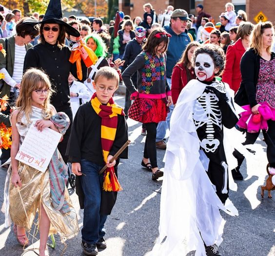 kids and parents dressed up at a Halloween festival